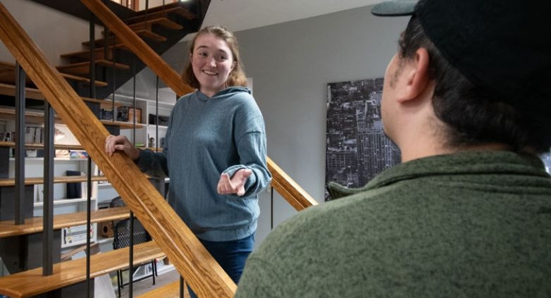 A couple stands on a stairway, representing the complexities of relationships and the importance of seeking help when needed.