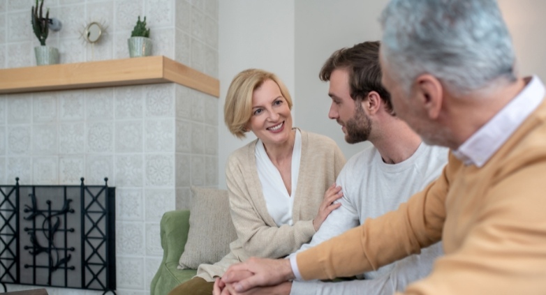 A family on a couch, showcasing on how to support an addict without enabling them.