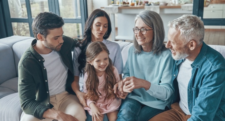 A family gathered on a couch, displaying warmth and unity while addressing emotional challenges related to alcoholism.