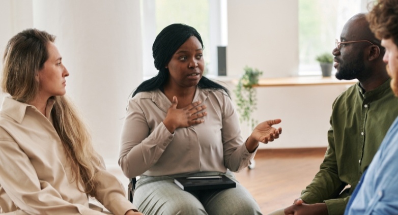 A group of people sitting in a circle, showcasing the supporting with sobriety and respecting personal boundaries.