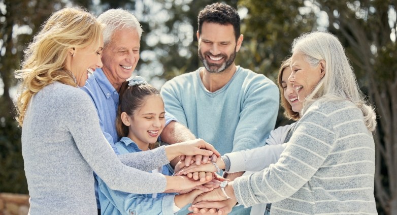 A united family holding hands, illustrating their commitment to support each other in long-term recovery from alcoholism.