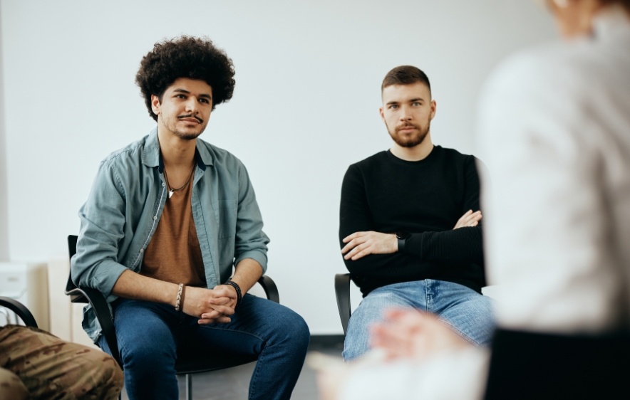 Three men in chairs talking to each other, focusing on marijuana addiction treatment services in Connecticut.