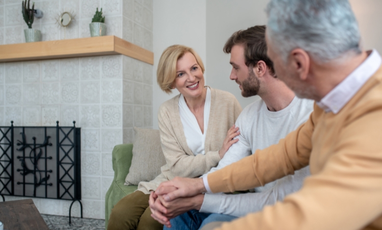 A family seated on a couch focusing on marijuana addiction treatment and family support services.