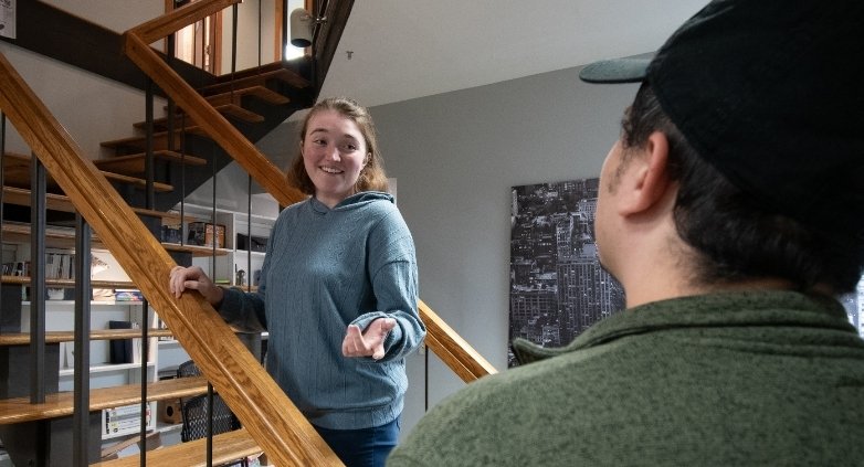A woman and a man on a stairway, illustrating the concept of enforcing love-based boundaries for addiction support.