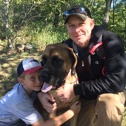 Andy Buccaro with a child and dog enjoying time outdoors, reflecting hope and family connection