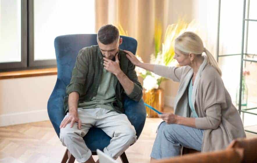 Therapist supporting a client during alcohol addiction recovery counseling session