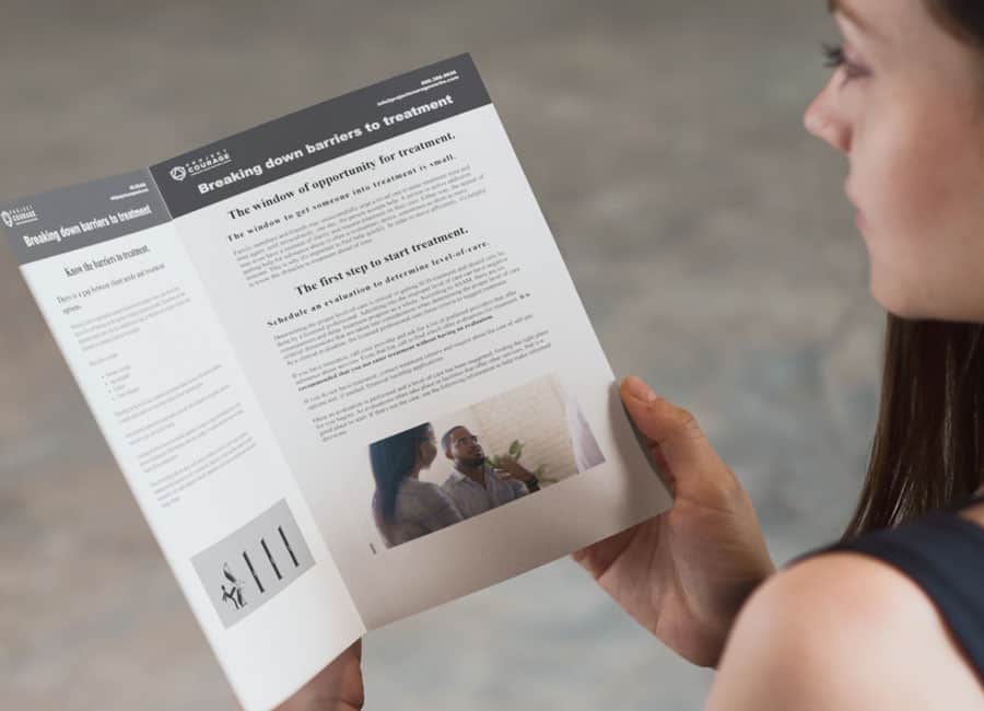 Woman reading information about recovery therapy services in Connecticut