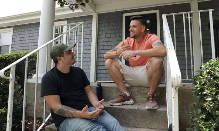 Two men talking on front steps during in-home addiction recovery in Essex, CT